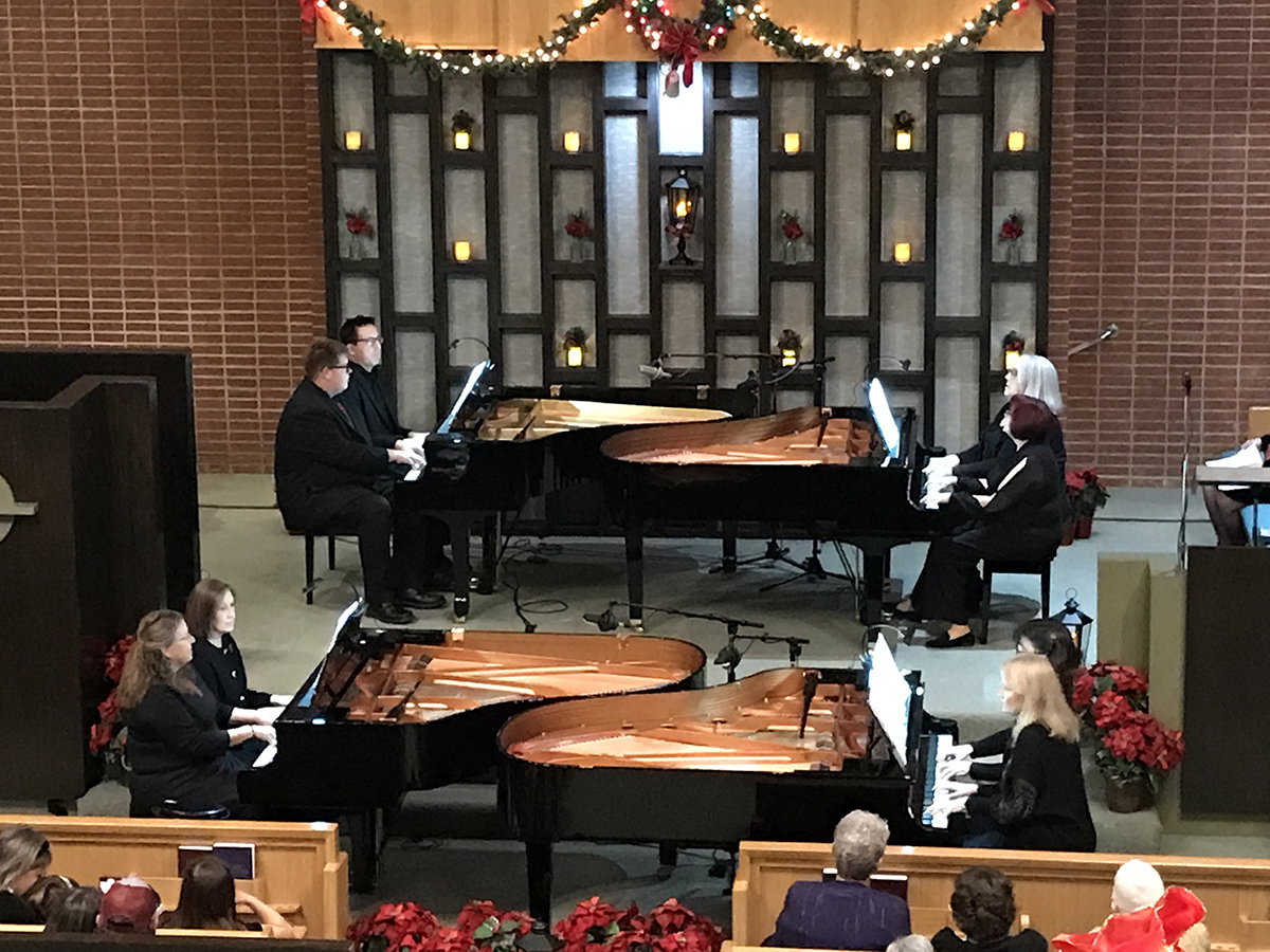 Keyboards at Christmas concert at the Presbyterian Church. Five pianos played by several different pianists.